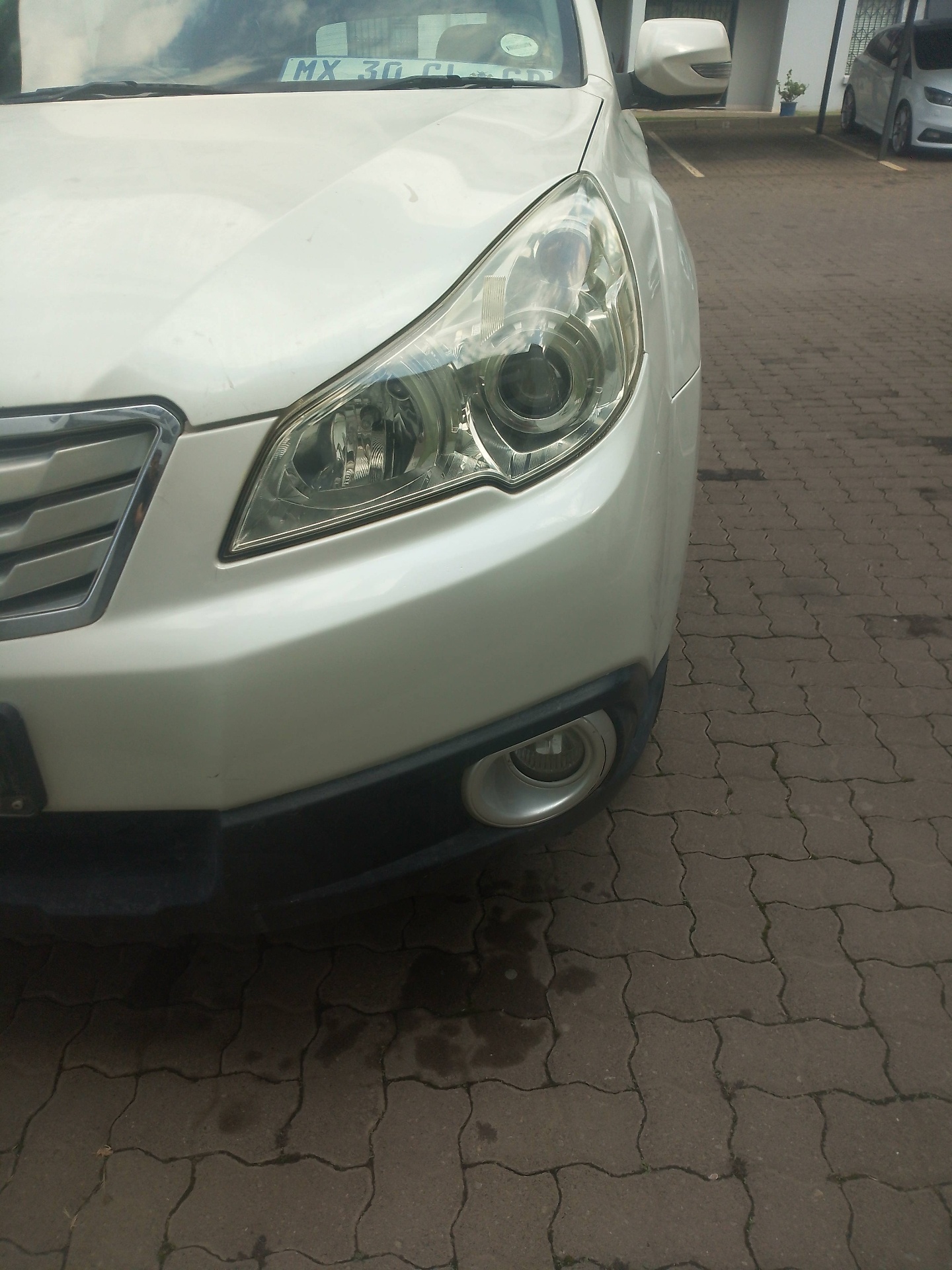 Technician polishing headlight